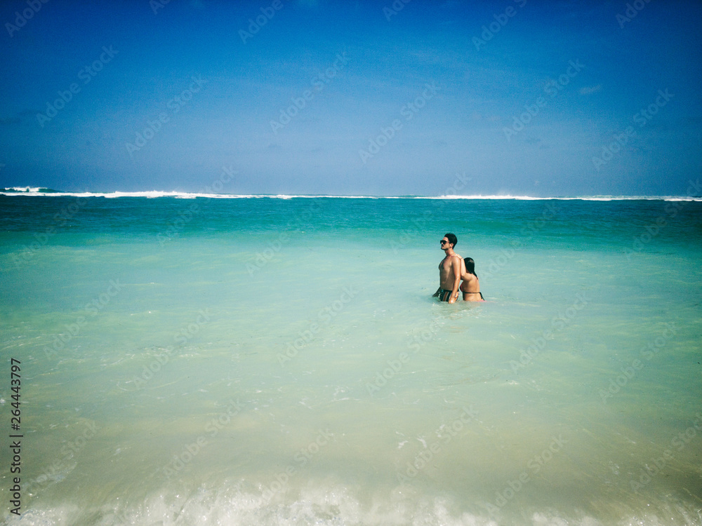 Couple enjoying on a sandy ocean tropical beach. Couple enjoying on a sandy ocean tropical beach.
