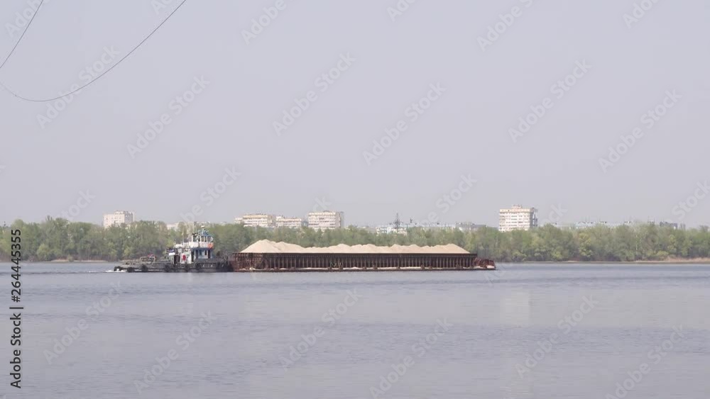 Barge loaded with river sand floating on the river Barge loaded with river sand floating on the river