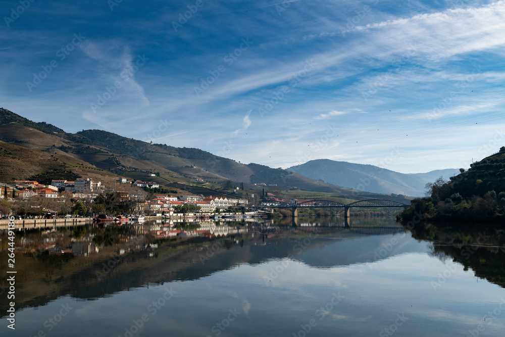 View of the Pinhao village with terraced vineyards and the Douro River, in Portugal; Concept for travel in Portugal and most beautiful places in Portugal