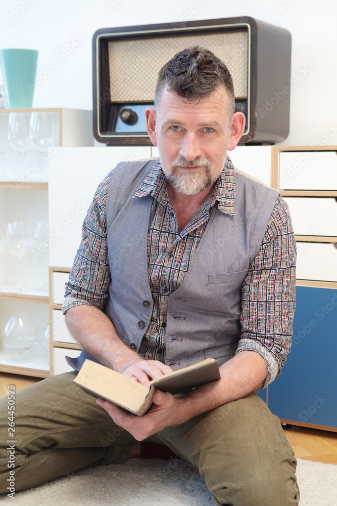 Fototapeta premium handsome man in his 50s reading a book