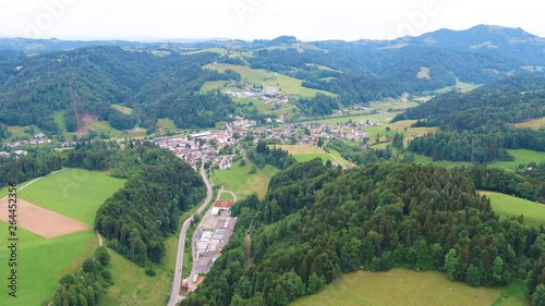 Lift up drone shot from a little village, direction of Bauma, Switzerland. Also visible an old spinning factory from the industialisation. photo