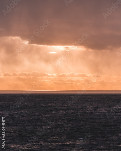 Sunset at sea with sunlight coming through the rain clouds, Finland