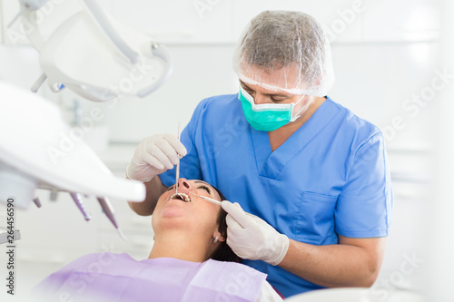 Fototapeta Naklejka Na Ścianę i Meble -  dentist professional filling teeth