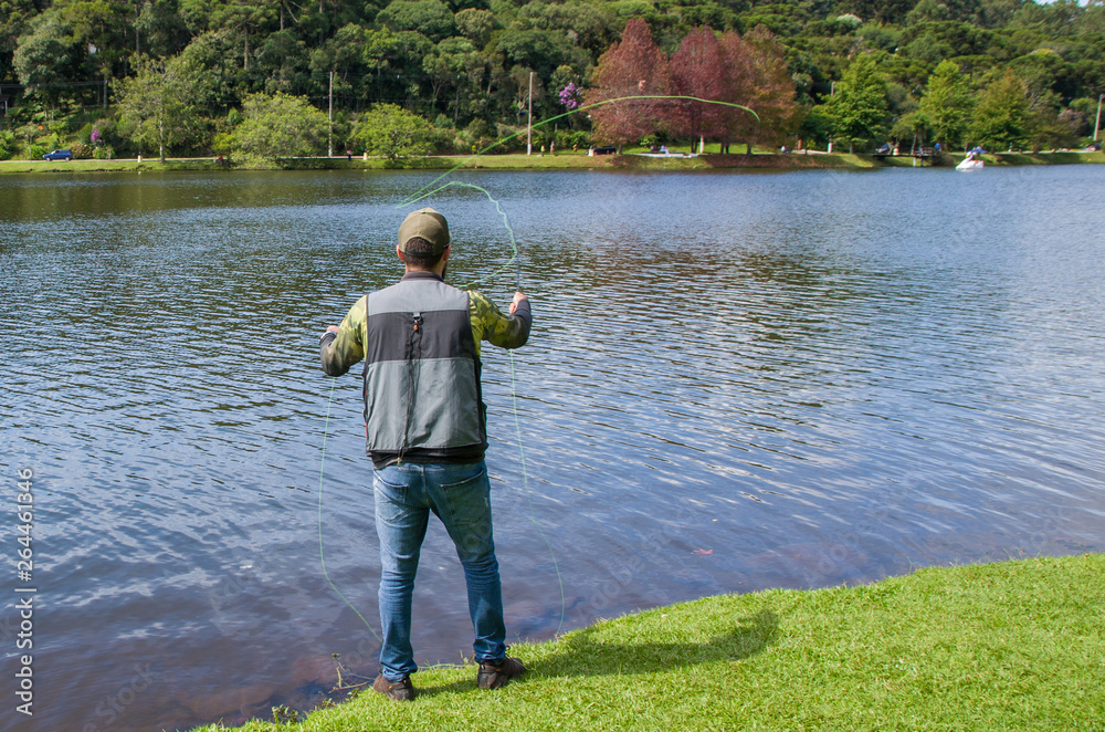 Flyfishing on the lake in Brazil, young fisherman fishing. Flyfishing on the lake in Brazil, young fisherman fishing.