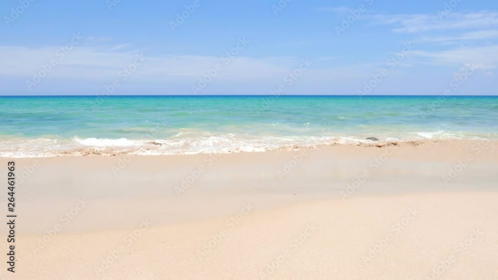 locked wide shot of white smooth sandy beach and turquoise ocean water on a sunny blue sky day, tranquil water and waves, no people and obstruction elements. tropical Thailand, copy space background locked wide shot of white smooth sandy beach and turquoise ocean water on a sunny blue sky day, tranquil water and waves, no people and obstruction elements. tropical Thailand, copy space background