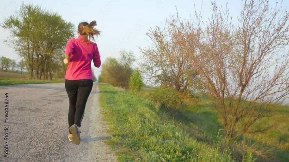 young woman running on the track doing sports, girl jogging to lose weight, healthy lifestyle concept, diet, sports in nature young woman running on the track doing sports, girl jogging to lose weight, healthy lifestyle concept, diet, sports in nature