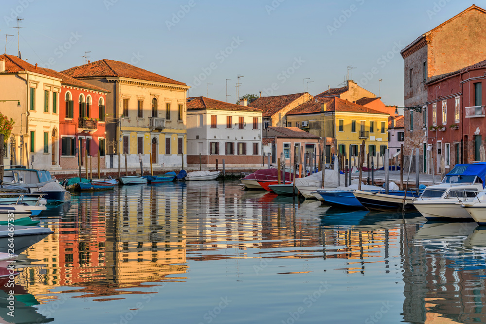 Sunset Canal - Sunset view of calm and colorful Canale San Donato on Murano Islands. Venice, Veneto, Italy. No trademark, logo or person in the image.