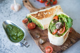 Burrito wraps with vegetables and sauce pesto.Roll with vegetables, mushrooms and pesto sauce. Vegetarian kebab. Of diet food.