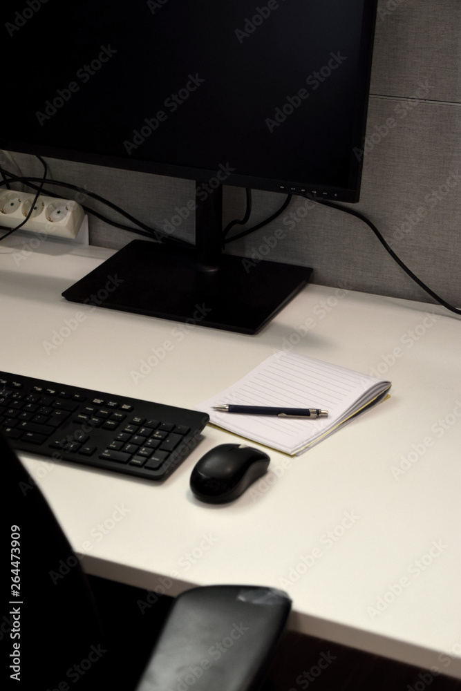 Office desk with screen, keyboard, computer mouse, notepad and pen Office desk with screen, keyboard, computer mouse, notepad and pen