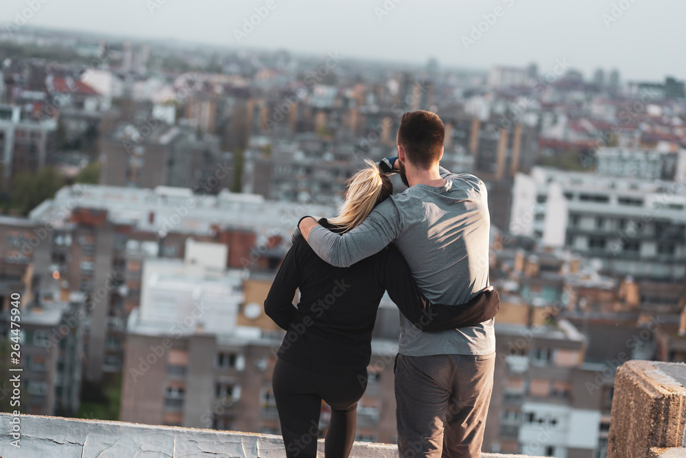 Couple on a building rooftop terrace