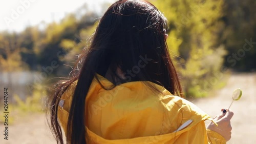 Young woman doing acrobatic flip on the nature, slow motion photo