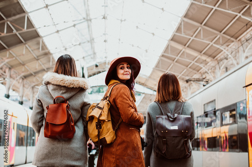 .A group of young friends waiting relaxed and carefree at the station in Porto, Portugal before catching a train. Travel photography. Lifestyle.