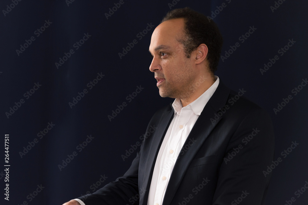 Young african american businessman at business conference room with public giving presentations. Audience at the conference hall. Entrepreneurship club.