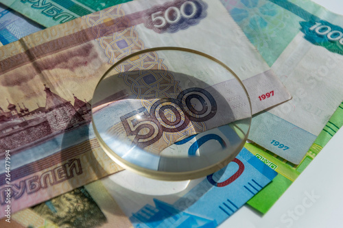 magnifying glass on 500 rubles banknote. business concept background. perfect illustration for russian financial and econimics news photo