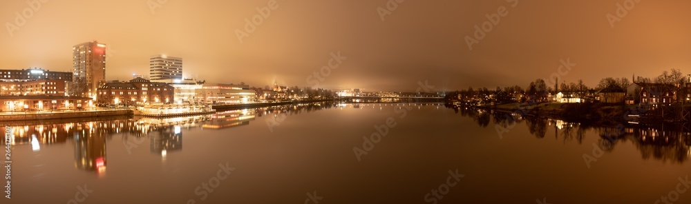 Panorama, foggy view from the central bridge over the river to the both sides of Umea city with old bridge in the middle, Vasterbotten municipality, Sweden