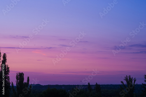 Landscape with dramatic light - beautiful golden sunset with saturated sky and clouds.