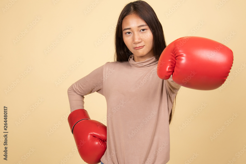Young Asian woman with red boxing gloves. Young Asian woman with red boxing gloves.