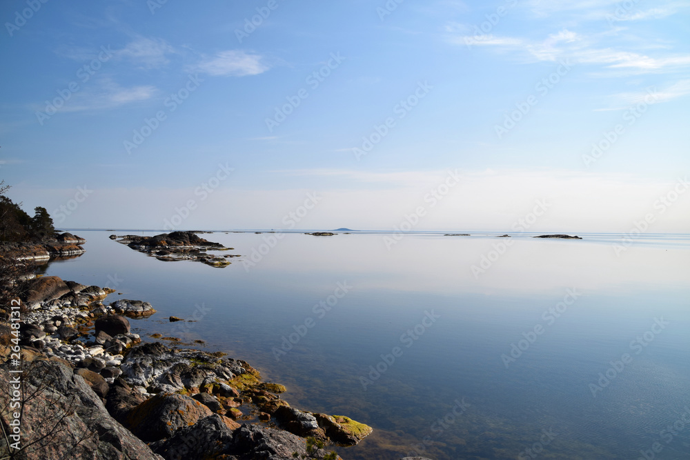 Early morning in the Swedish archipelago with tranquil water and the island -and national park - 