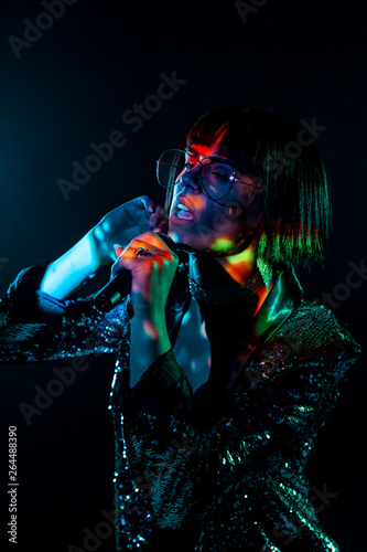 Stylish woman singing on stage photo