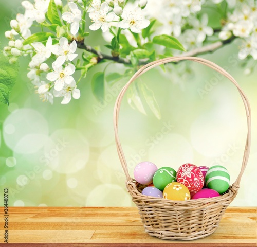 Easter basket filled with colorful eggs on