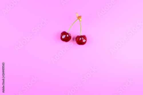 red cherries isolated on pink background