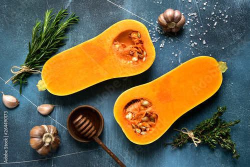 Photos Halves of raw organic butternut squash with ingredients for making