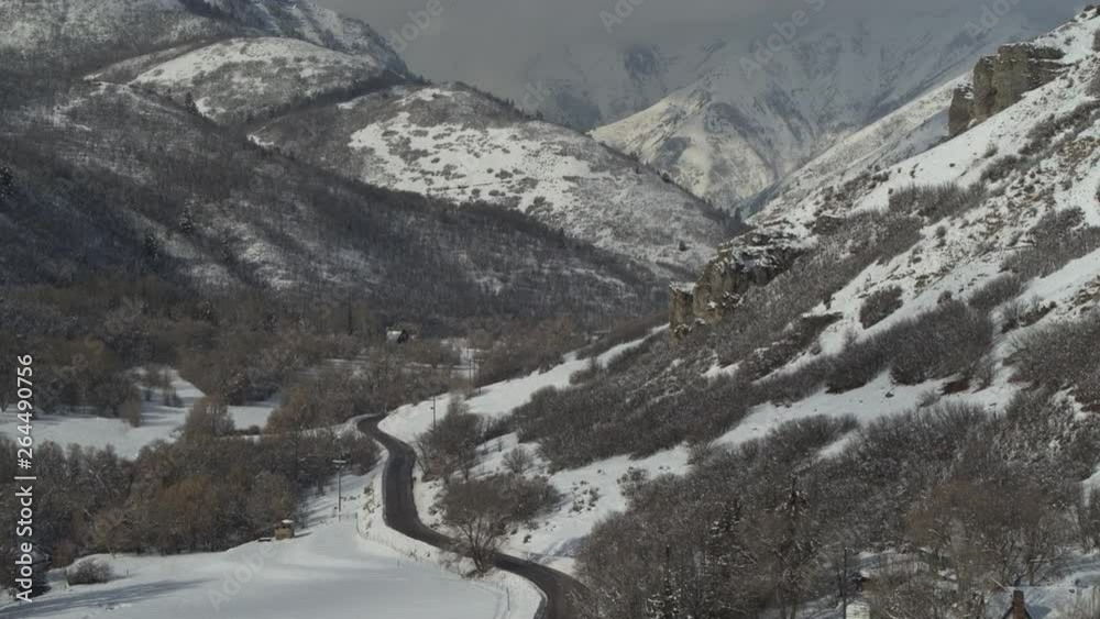 Aerial view of winding road in mountain range in winter / South Fork, Utah, United States Aerial view of winding road in mountain range in winter / South Fork, Utah, United States