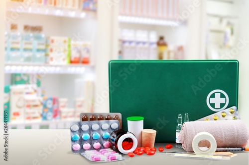 First aid kit with medical supplies on light background