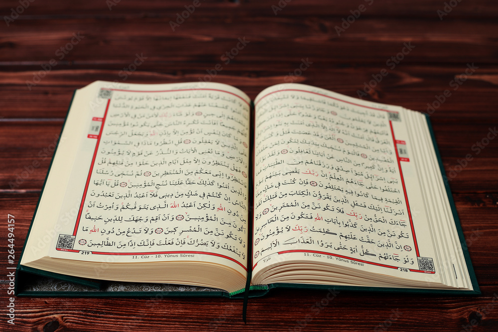Islamic Holy Book Quran with rosary beads on wooden table background. Kuran the holy book os Muslims. Ramadan concept. Islamic Holy Book Quran with rosary beads on wooden table background. Kuran the holy book os Muslims. Ramadan concept.