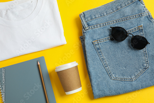 Photos Flat lay composition with women clothes and creative accessories on yellow background