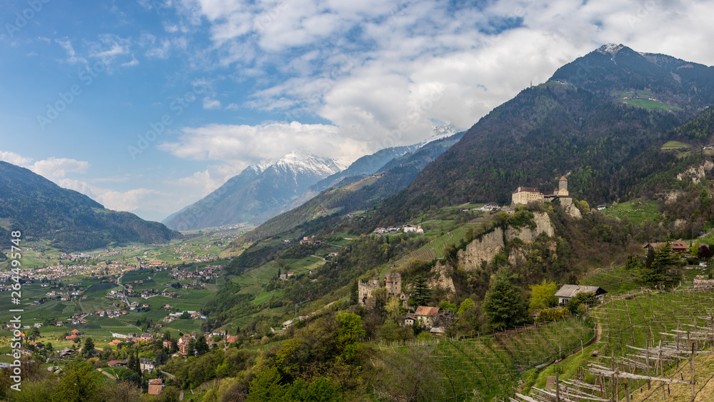 Panoramic view on Tyrol Castle with Castle Brunnenburg inside Valley and Alps of Meran. Tirol Village, Province Bolzano, South Tyrol, Italy.