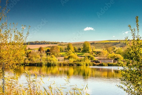 HDR image of a lake in England.emphasis is on the yellows and golds of the autumn trees. photo