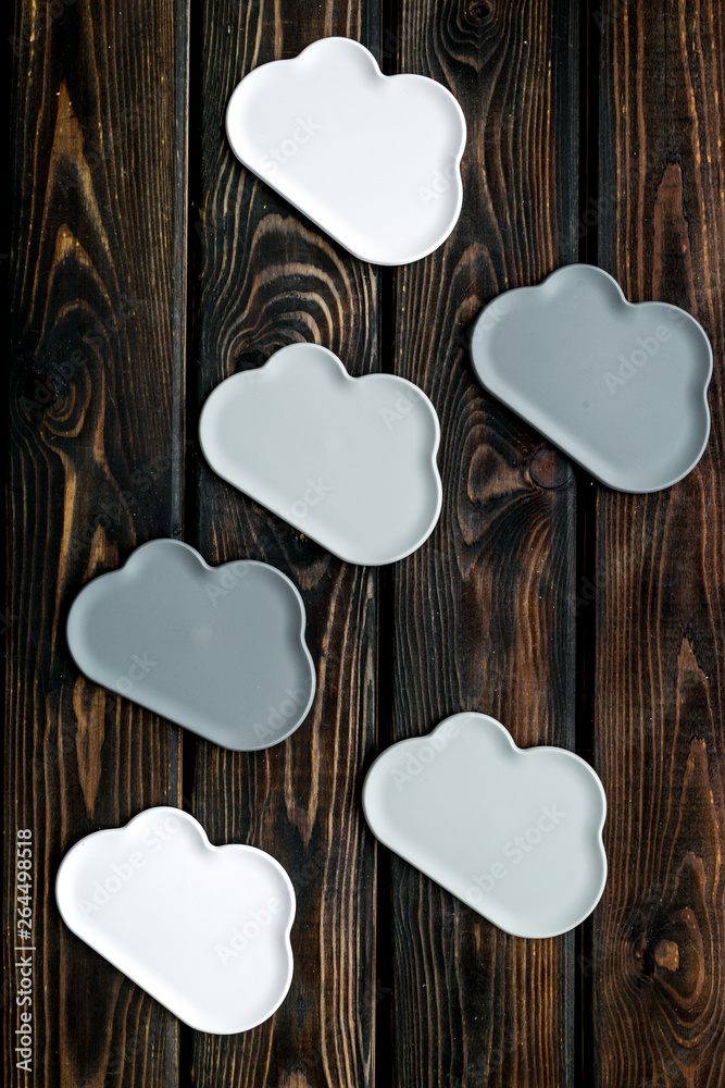 Fototapeta premium cloud service concept with clouds on wooden background top view