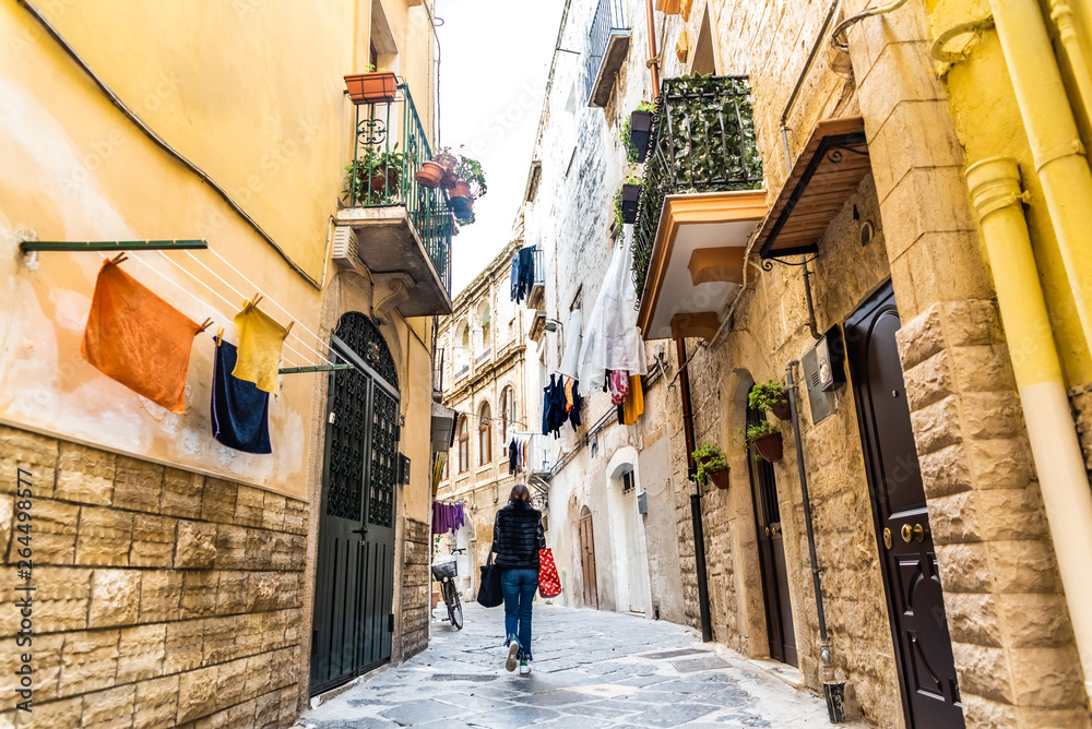 Bari, Italy - March 12, 2019: People walking through the alleys of the old city of Bari.