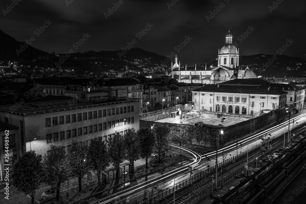 the Italian city of Como shot in a panorama from above with lights, traffic, buildings and the cathedral