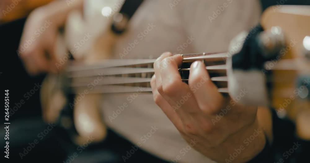 Fingers pinch chords on the strings. Man professionally plays the guitar. Close-up. Fingers pinch chords on the strings. Man professionally plays the guitar. Close-up.