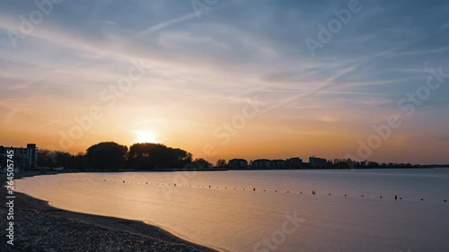 Time lapse of the sunset at a lake in spring. Shot at the Gooimeer, Huizen, The Netherlands on April 22, 2019. photo