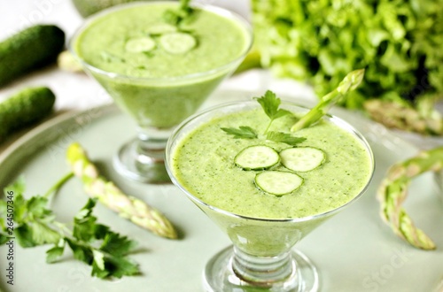 soup puree from avocado, asparagus and cucumber. Dietary detox diet. Vegetarian dish. serving soup in a glass bowl.