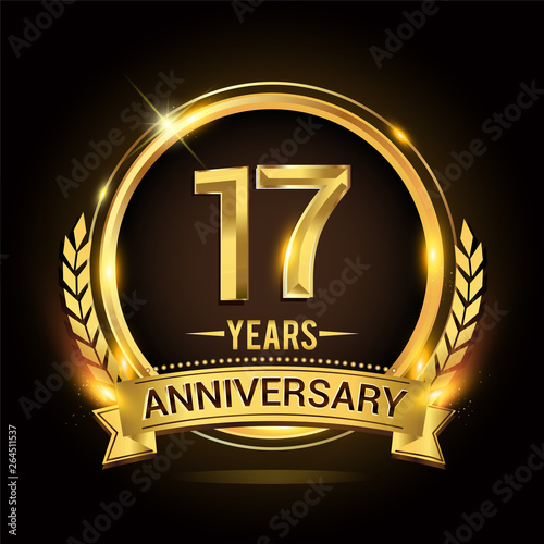 Celebrating 17th years anniversary logo with golden ring and ribbon, laurel wreath vector design.