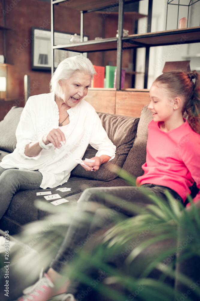 Granny and girl having much fun while doing homework together Granny and girl having much fun while doing homework together