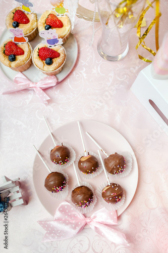 Chocolate lollipop on pink background