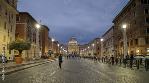 photographer takes a shot of st peters from via conciliazione, rome photo