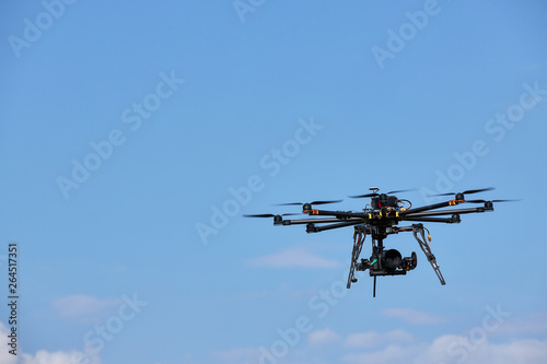 Fototapeta Naklejka Na Ścianę i Meble -  Demonstration of flight oktokopter. Unmanned aerial vehicle against the sky.