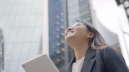 Camera circling a young Asian female in the city, in slow motion