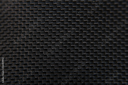Black carbon texture background. Dark textile pattern background. Detail of synthetic material.