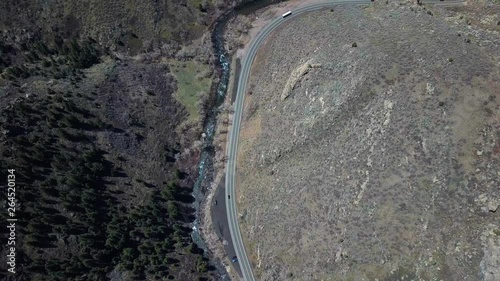 Cinematic Drone Aerial Bird View Footage of Road With Cars by Clear Creek River Beetween Ricky Hills of Lookout Mountain Denver Colorado 4k photo