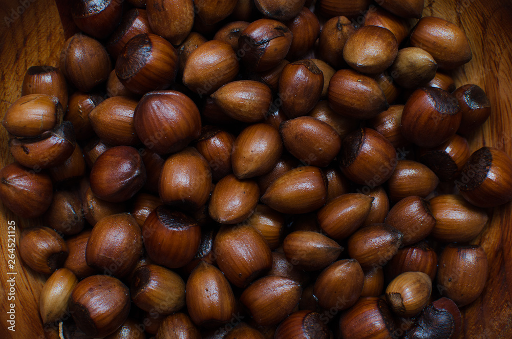 hazelnuts scattered on boards, photographed from above, forming a uniform background hazelnuts scattered on boards, photographed from above, forming a uniform background