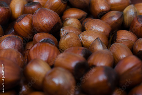 hazelnuts scattered on boards, photographed from above, forming a uniform background