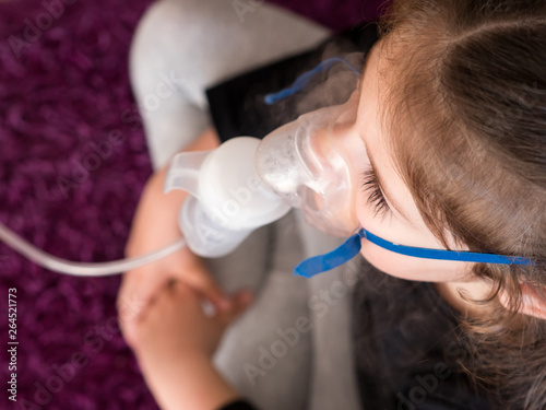 Little girl with oxygen mask top view