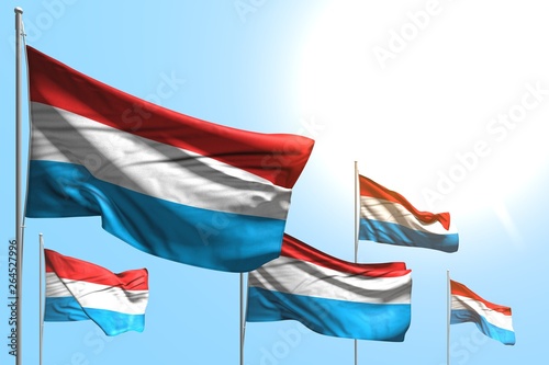 beautiful 5 flags of Luxembourg are wave on blue sky background - any feast flag 3d illustration..